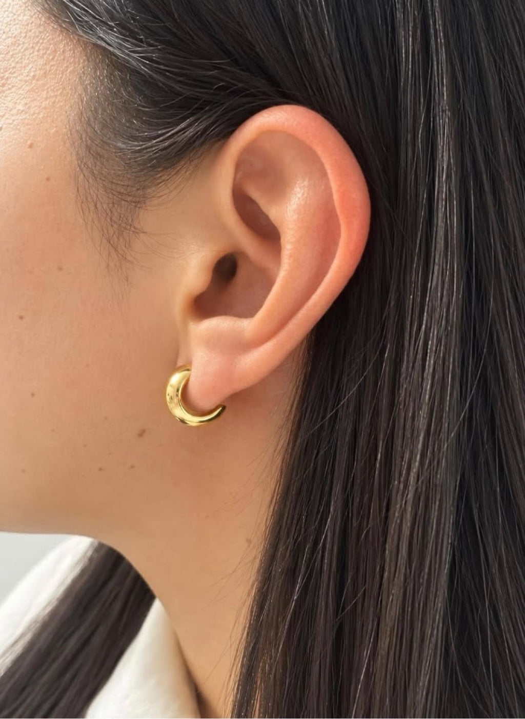 Lucia Crescent Hoops — gold C-shaped dome hoop on ear