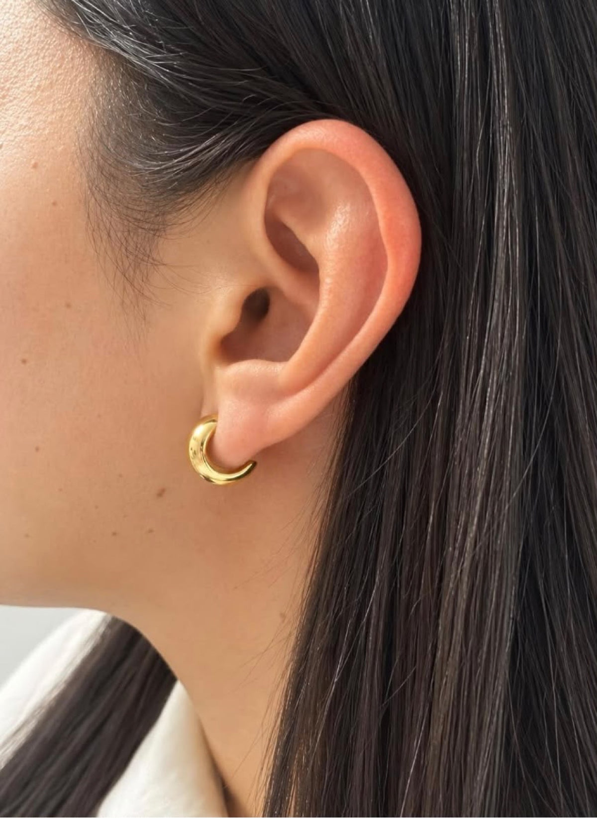 Lucia Crescent Hoops — gold C-shaped dome hoop on ear
