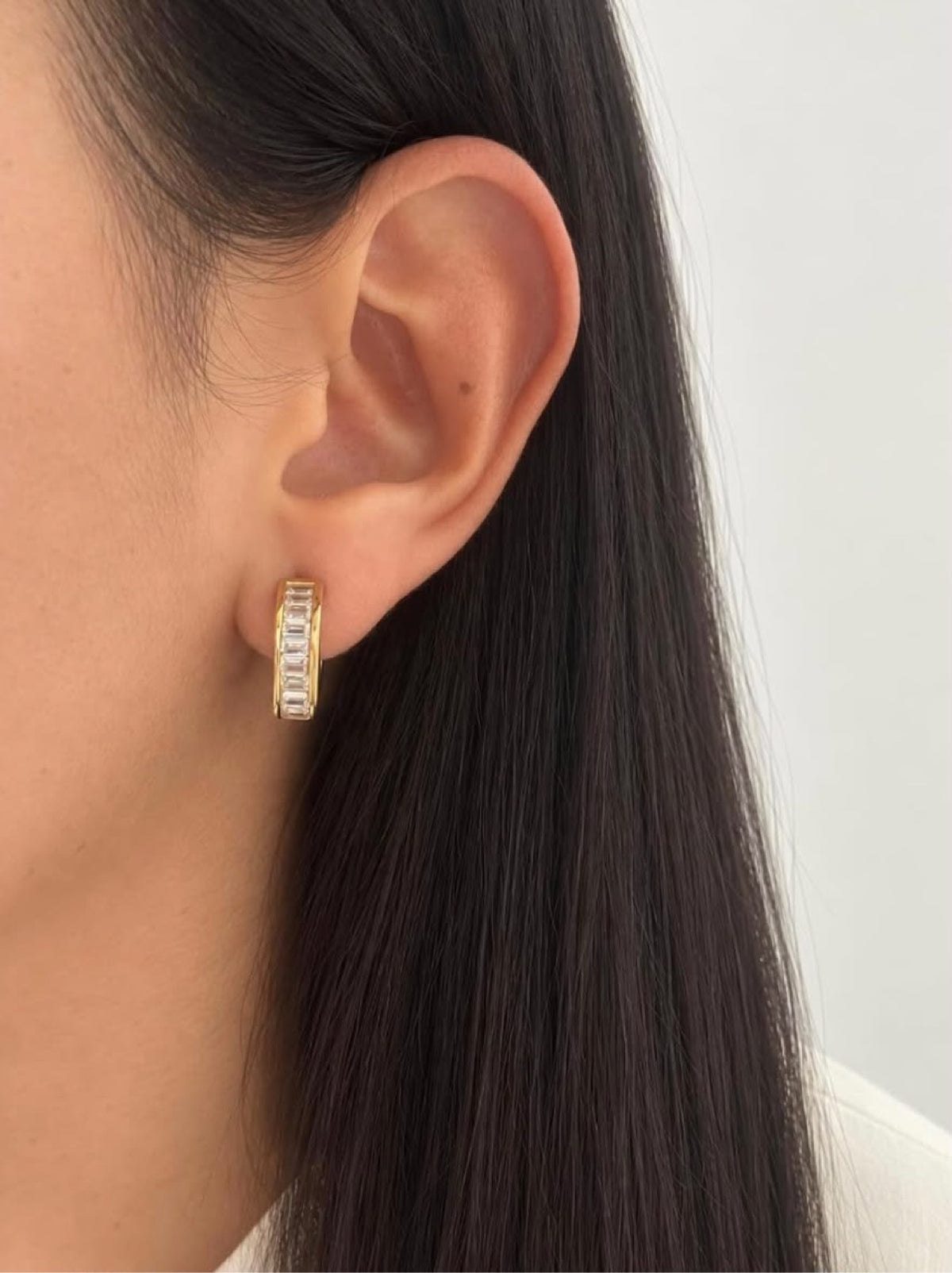 Close-up of The Crystal Baguette Hoops on ear