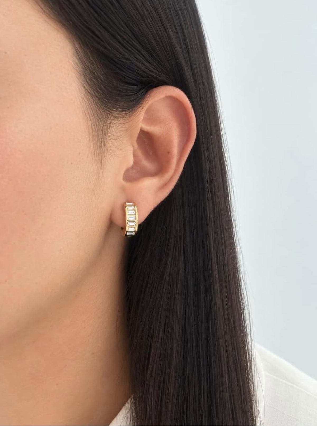 Close-up of Tina Baguette Hoops on ear